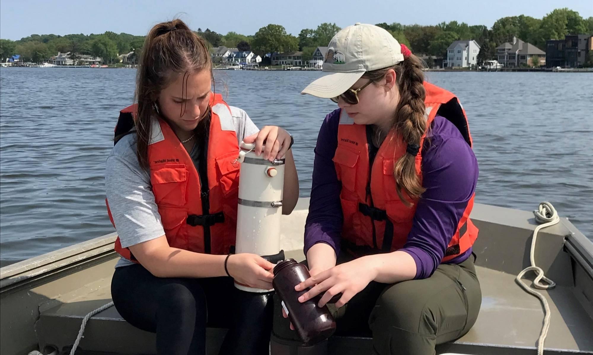 Two undergraduate students sample water quality for the Bear Lake watershed assessment project.